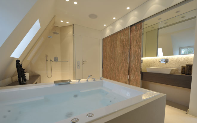A beautiful modern bathroom containing a luxury whirlpool spa bath